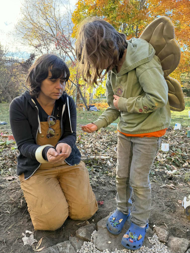 Ioana sharing swamp milkweed seeds with a tiny participant at one of our Butterflyway Aylmer plantings